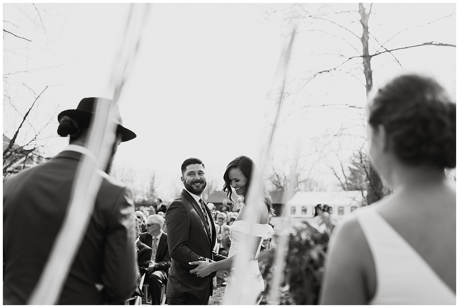 Jenny and Andrew share some newlywed joy and laughter at their bohemian alter. 